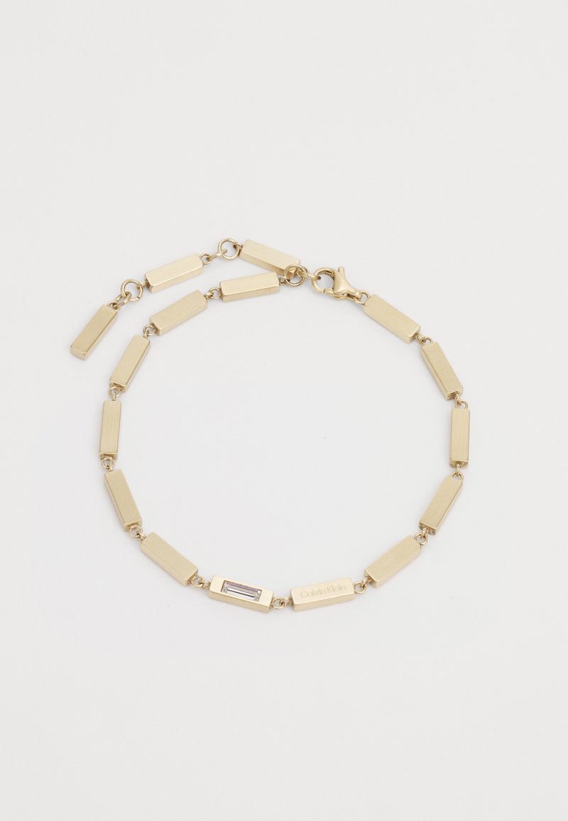 Gold chain bracelet featuring rectangular links with a small rectangular accent and clasp closure. Smooth, polished metal finish.