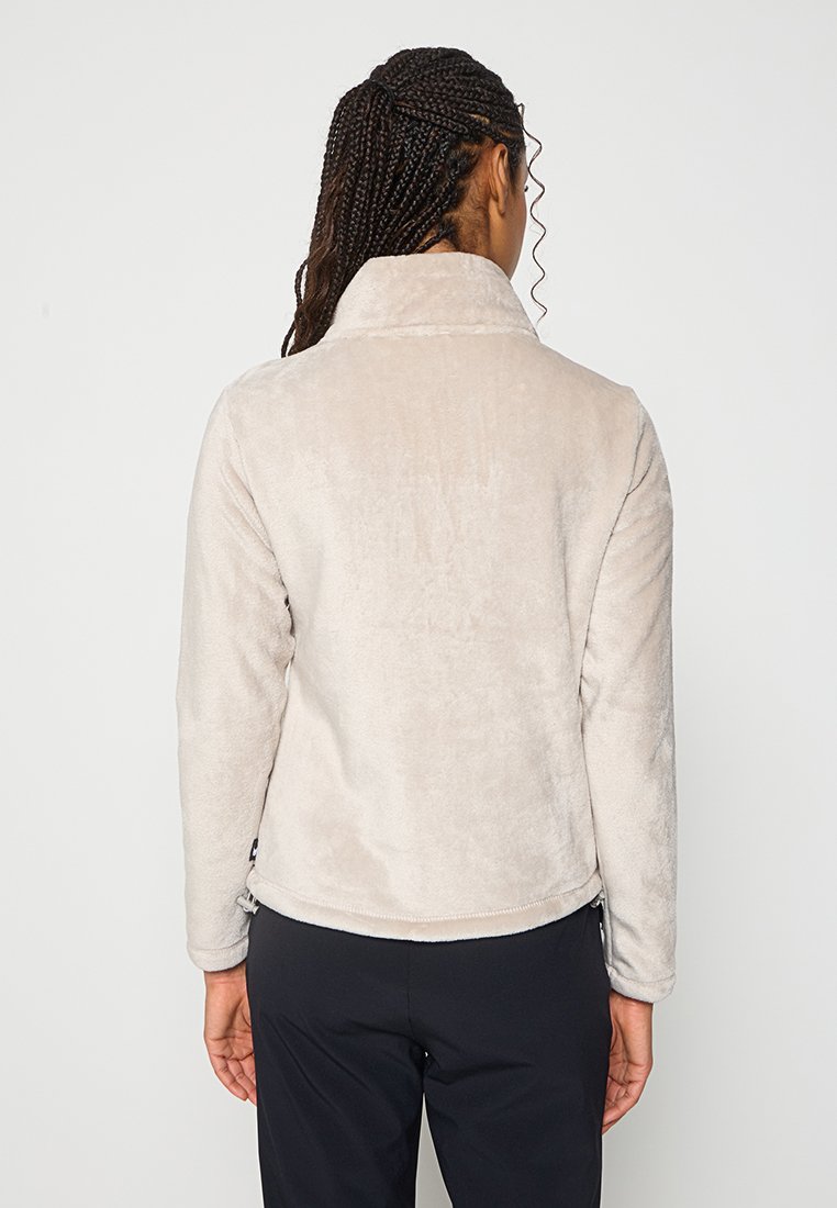Beige Fleecejacke mit Kragen, glatter Textur und abgerundetem Saum. Verfügt über Seitentaschen und einen Reißverschluss am unteren Ende.