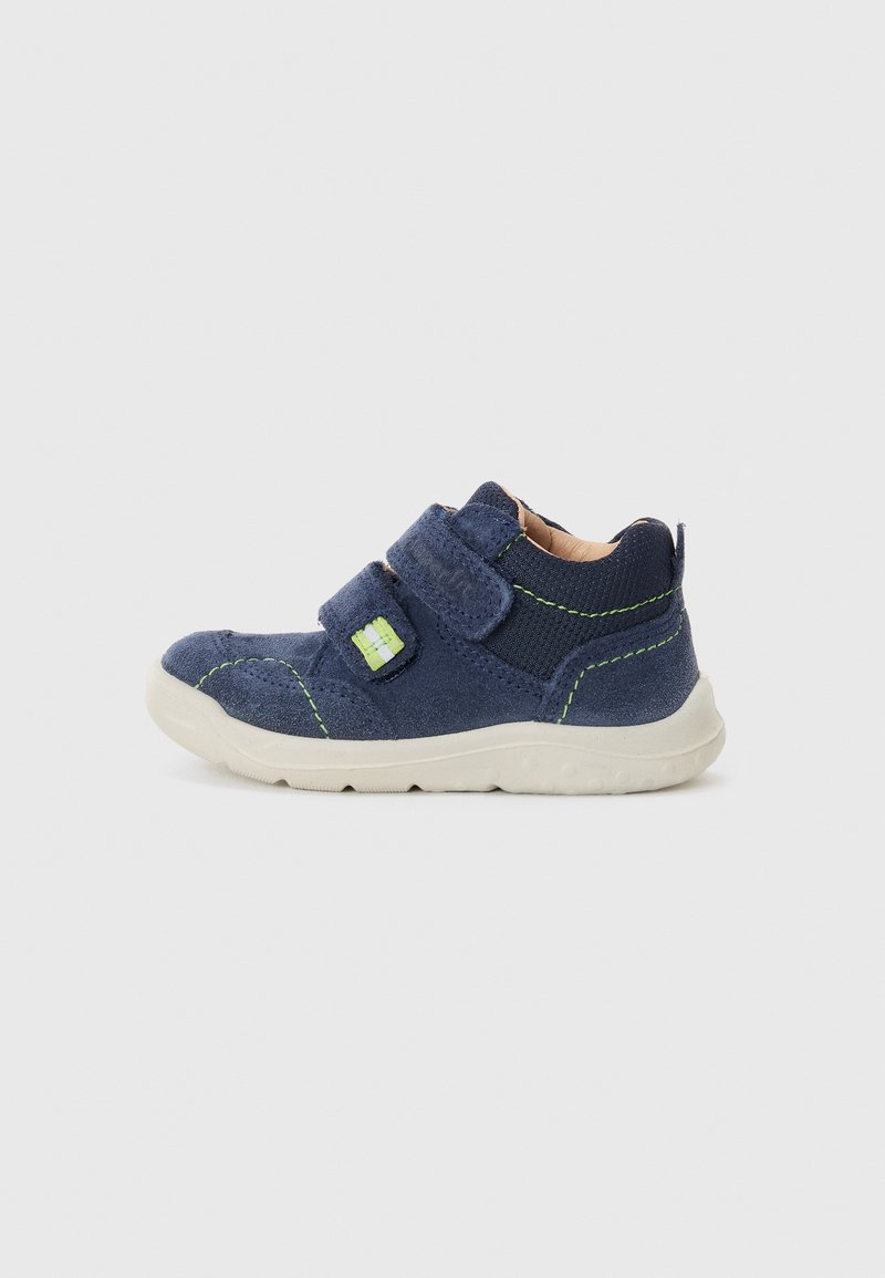 Navy blue suede shoe with a textile upper, two Velcro straps, green stitching accents, and a light rubber sole.