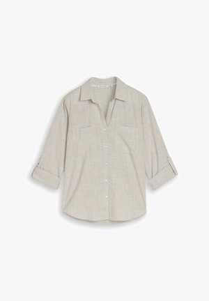 Chemise beige à boutons avec manches retroussées et deux poches poitrine à l'avant, présentant un motif à carreaux discret.