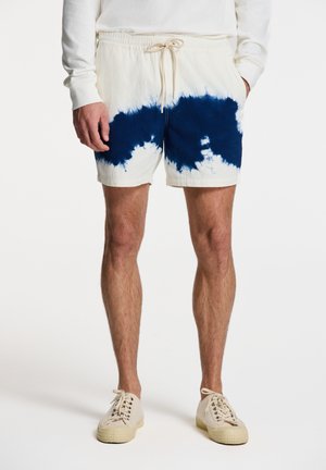 Pamučne kratke hlače u krem boji s plavim tie-dye uzorkom, s elastičnim pojasom i vezicom te opuštenim krojem.