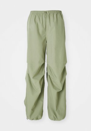 Light green, elastic waistband pants with a loose fit, featuring gathered side detail and cuffs. Made from a smooth fabric.