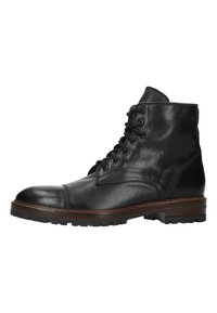 Zwarte leren veterschoen met een ronde neus, stevig rubberen zool en een gladde afwerking. Heeft contrasterende bruine rand rond de zool.