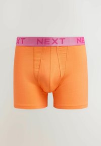 Narancssárga pamut boxer alsónadrág rózsaszín rugalmas derékkal, amelyen vastag betűkkel a "NEXT" felirat található. Simasága és testhezálló kialakítása jellemzi.