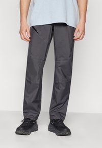 Gray lightweight pants with a smooth texture, featuring a side zip pocket and tapered design, paired with black athletic shoes.