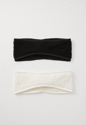 Two headbands: one black with a textured, fuzzy top, and one white with a similar texture. Both have a smooth underside and twisted design.