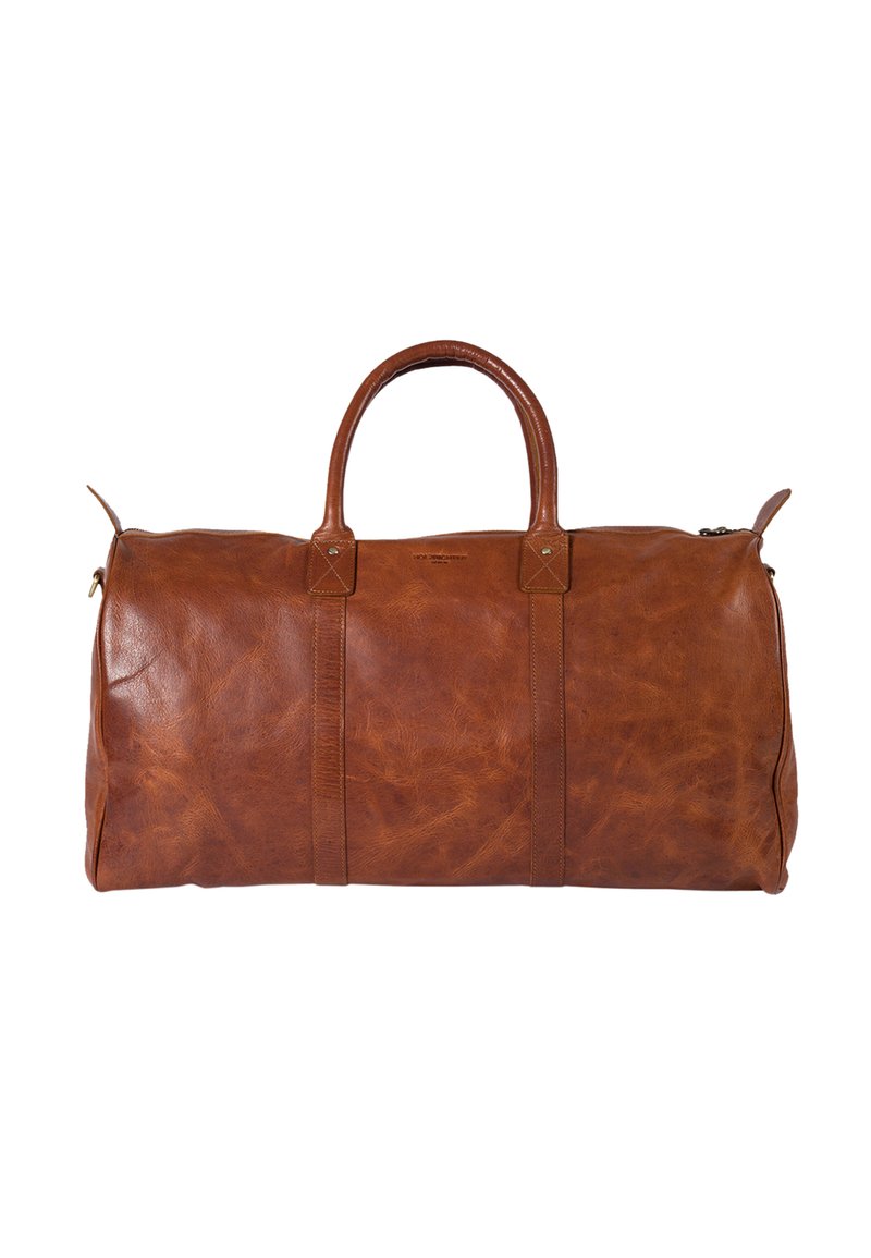 Brown leather duffel bag with a smooth texture, rounded handles, two side straps, and a zipper closure. Features minimalist design and brass hardware.