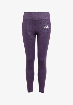 Leggings violets avec un motif texturé ressemblant à des rayures animales, dotées d'une taille élastique et d'un logo blanc sur la hanche.