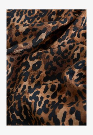 Löwenmusterstoff mit einer Kombination aus braunen und schwarzen Flecken auf einer strukturierten, weichen Oberfläche, die ein dynamisches visuelles Muster erzeugt.
