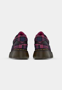 Black sneakers with a purple and pink plaid pattern, featuring a rubber sole and textured finish, with contrasting stitching details.