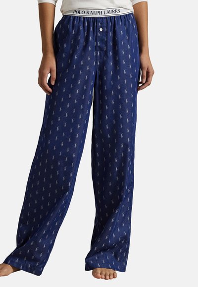 Mörkblå pyjamasbyxor med en horisontell midjebandsdetalj med texten "POLO RALPH LAUREN", prydda med små, upprepande loggor i en ljusare nyans.