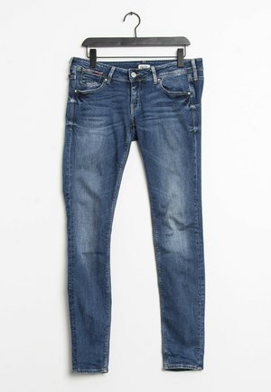 Modré džíny skinny z denimu s středním vypráním, pět kapes, stříbrné kovové doplňky a mírné vyblednutí ve struktuře látky.