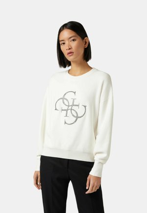 Felpa bianca con una vestibilità relaxed, caratterizzata da un design grafico con accenti metallici al centro. Polsini e orlo a costine. Pantaloni neri.