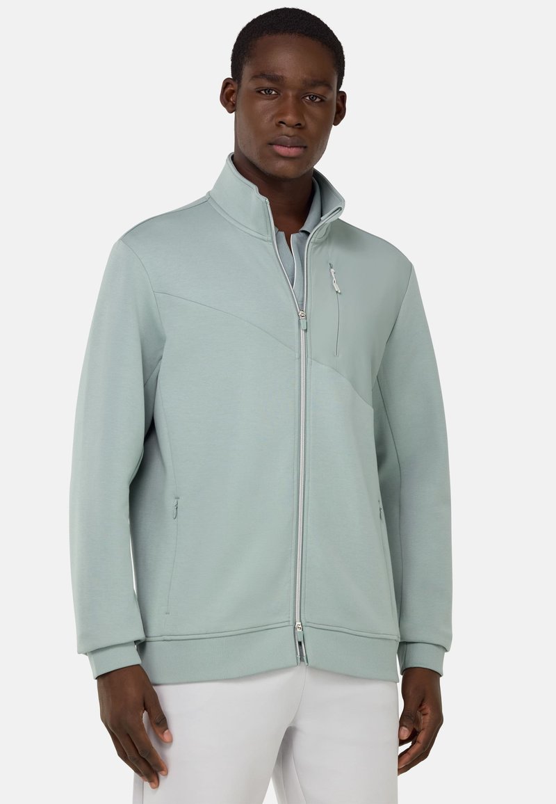 Giacca zip-up blu-verde chiaro, con colletto alto, tasche laterali e pannellatura testurizzata sul davanti per un tocco di dettaglio e stile.