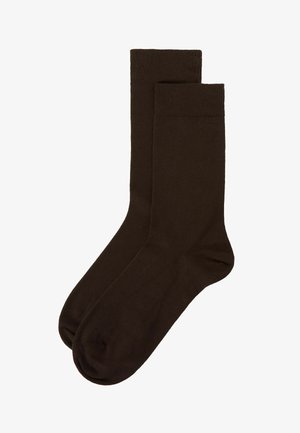 Brune bomuldsstrømper med en glat tekstur, ribbet kant og et klassisk knæhøjt design. Enkle, ensfarvede uden synlige mønstre eller accenter.