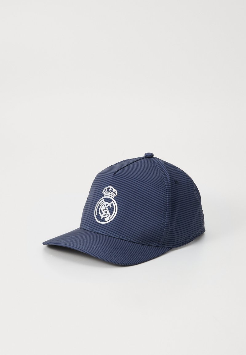 Navy blue cap featuring striped texture, a flat brim, and a white Real Madrid logo with a crown accent on the front.