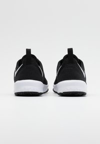 Scarpe sportive nere con una tomaia in tessuto testurizzato, intersuola bianca e suola in gomma nera. Presentano un pratico pull tab sul tallone.