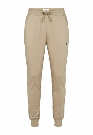 Puha anyagból készült bézs szabadidőnadrág, gumis derékrésszel és állítható zsinórral, oldal zsebekkel és bordázott szegéllyel. Kis logó a lábszáron.
