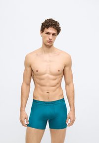 Cuecas boxer teal da Calvin Klein com cós preto com logótipo, design ajustado e tecido liso e elástico.