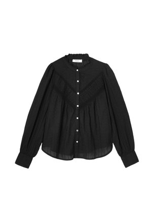 Blouse noire à manches longues avec col à volants, devant boutonné, motif texturé en forme de V sur la poitrine, et poignets froncés.