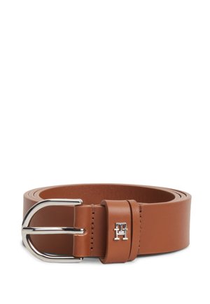 Ceinture en cuir marron avec boucle en métal argenté et boucle passant avec un petit logo argenté « TH », enroulée sur fond blanc.