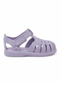 Purple rubber sandal with a closed toe, open sides, and adjustable strap. Features a textured upper and a flexible, slip-resistant sole.