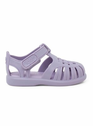 Purple rubber sandal with a closed toe, open sides, and adjustable strap. Features a textured upper and a flexible, slip-resistant sole.