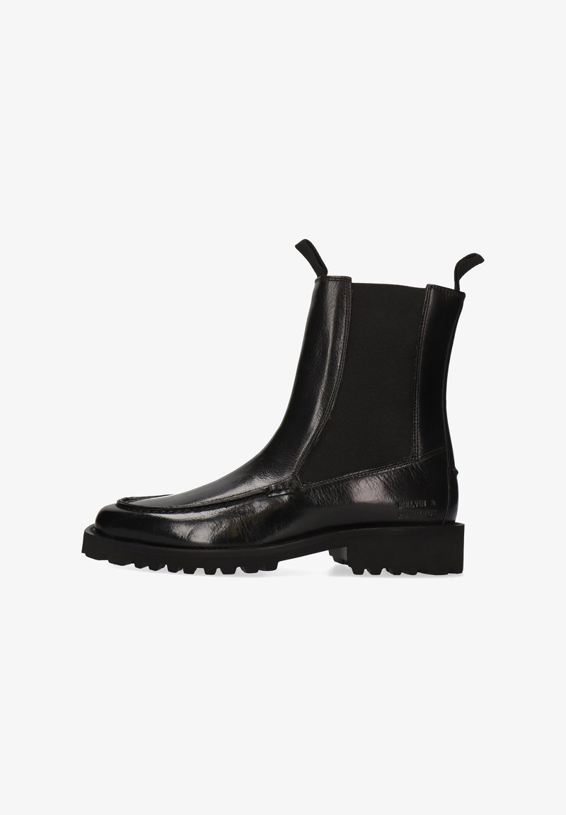 Botas Chelsea de cuero negro con paneles laterales elásticos, punta redondeada, superficie texturizada y suela de goma resistente. Tiradores en la parte trasera.