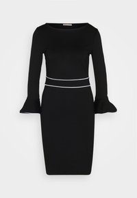 Zwart jurkje met lange mouwen en klokvormige manchet. Heeft een getailleerde silhoutte en witte accenten bij de taille, gemaakt van rekbaar materiaal.