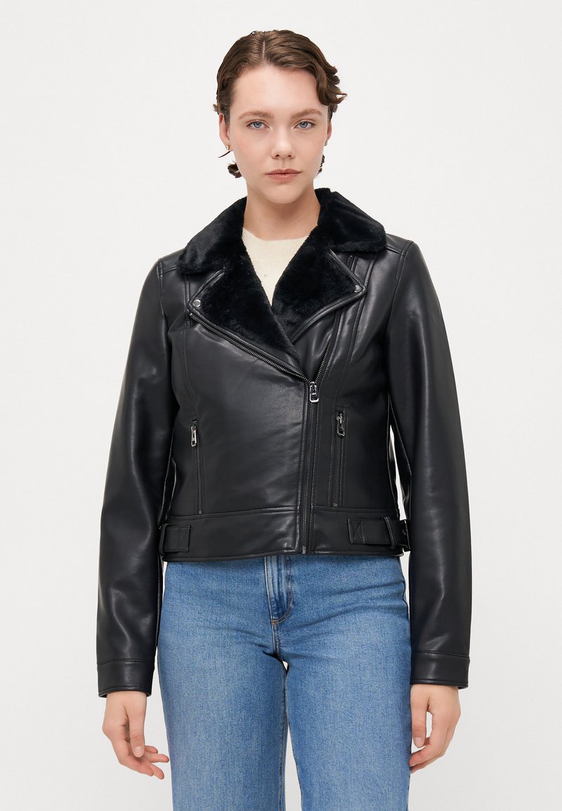 Black leather jacket with a faux fur collar, zippered pockets, and a cropped design. Smooth texture with a tailored fit.