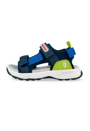 Sandalia para niños en azul marino y verde lima con correas ajustables azul y azul marino, suela blanca y plantilla gris texturizada.
