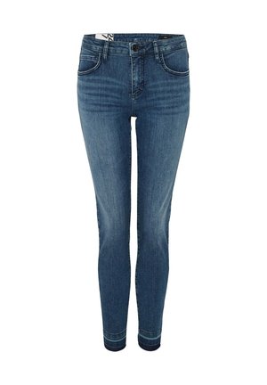 Skinny jeans in medium blue denim with a smooth texture. Features five pockets, button closure, and subtle stitching detail.
