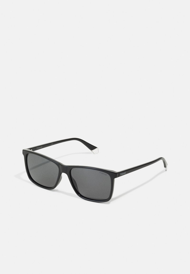 Black plastic sunglasses with square frames, dark lenses, thin arms, and silver accents on the tips. Polaroid branding visible on the arm.