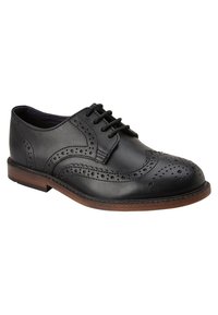 Chaussure de ville noire en cuir avec des détails de brogue, bout arrondi et design à lacets. Dotée d'une semelle intercalaire marron et d'une finition lisse.