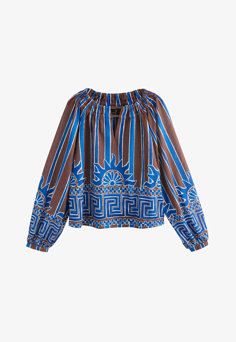 Blouse marron avec des rayures verticales bleues et blanches, motifs de soleil et géométriques, encolure et poignets élastiques, manches longues bouffantes.