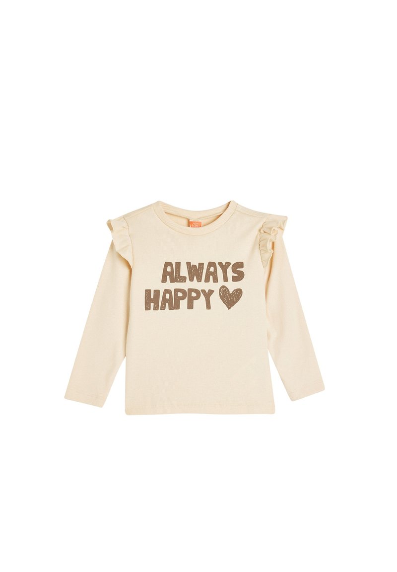 Cremefarvet skjorte med lange ærmer, der har rynkede detaljer på skuldrene, med brun skrift, der siger "ALWAYS HAPPY" og et hjerte grafik.