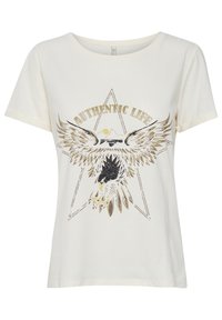 Kurzärmliges Creme-T-Shirt mit einem metallischen goldenen und schwarzen Adler-Graphic, umgeben von einem Stern und dem Text "AUTHENTIC LIFE." Aus Baumwollmaterial.