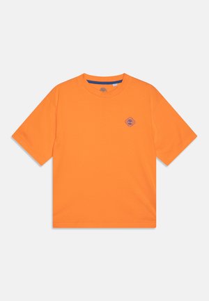 Pomarańczowa koszulka z krótkim rękawem z bawełny, z okrągłym logo w kolorze fioletowym na lewej stronie klatki piersiowej oraz prążkowanym dekoltem.