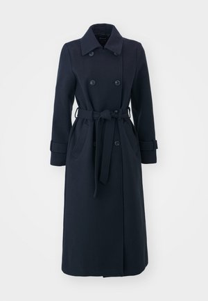 Marineblå trenchcoat laget av ullblandingsstoff, med dobbelspent front, belte i midjen og sidelommer.