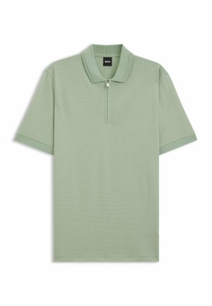 Short-sleeve polo shirt in light green with a textured fabric, half-zip front, and ribbed collar; features contrasting sleeve accents.