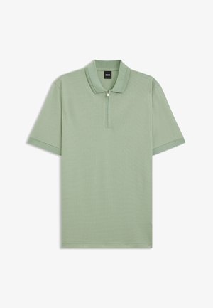 Short-sleeve polo shirt in light green with a textured fabric, half-zip front, and ribbed collar; features contrasting sleeve accents.