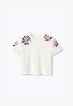 Chemise blanche à manches courtes avec col rond, présentant des motifs floraux colorés en perles sur les épaules et les manches.