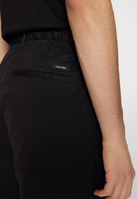 Calvin Klein MODERN RELAXED WIDE - Broek - black
