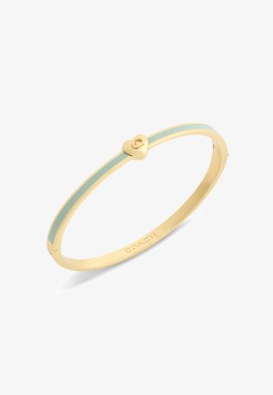 Gold bangle bracelet with a light blue enamel stripe and a small heart-shaped clasp, branded "Coach" on the inner side.
