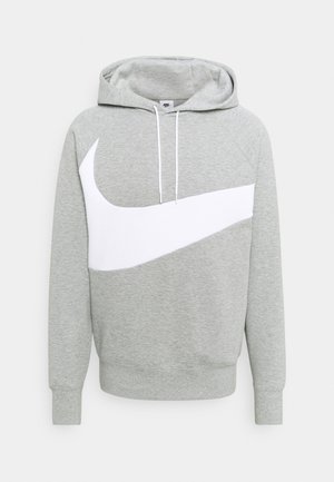 Lichtgrijze hoodiesweater met witte trekkoorden en een grote witte Nike-swoosh aan de voorkant.