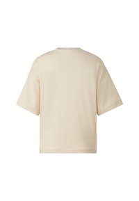 Krémově zbarvené tričko s krátkými rukávy vyrobené z hladké látky. Má kulatý výstřih a volný střih. Jednoduchý design bez viditelných vzorů.