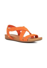 Orange suede sandals with crisscross straps, flat rubber sole, and a small metallic accent on the outer side.