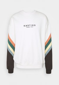 Felpa bianca in cotone con collo tondo. Presenta strisce colorate arancioni, verdi, blu e gialle lungo le maniche e il logo.