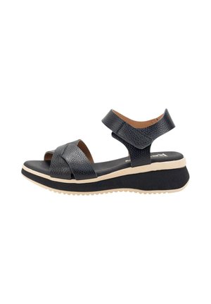 Sandalias de cuña de cuero negro con dos correas cruzadas y correa ajustable en el tobillo. Parte superior texturizada y suela de goma ligera.