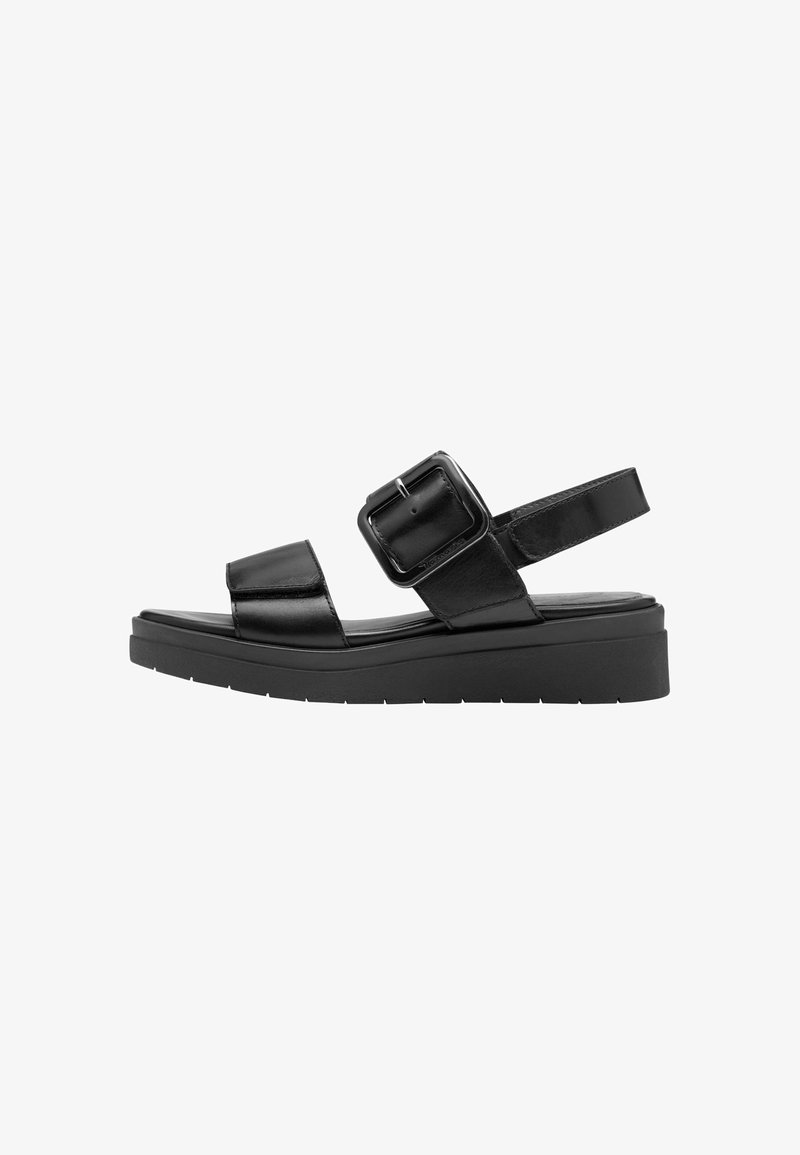 Black leather sandals with a wide ankle strap and large buckle. Thick, cushioned sole with a slight platform. Simple, modern design.